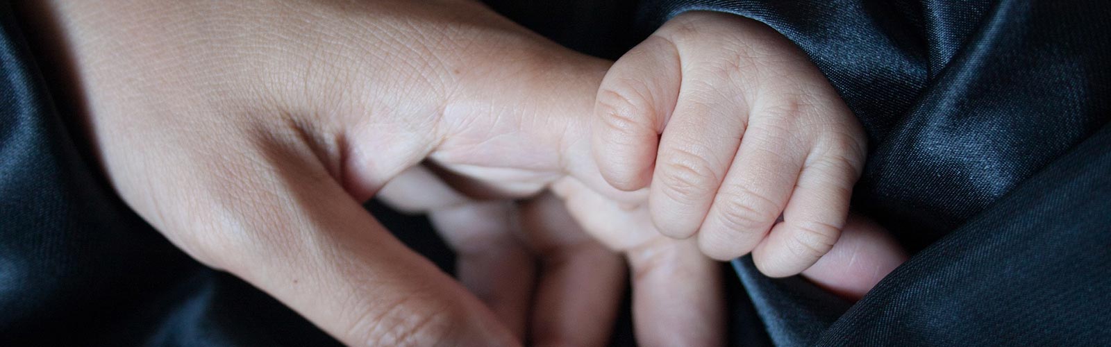 parent and child's hands touching